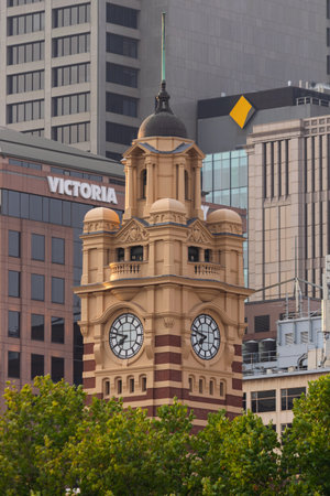 MELBOURNE, AUSTRALIA - 18 January 2020: The Flinders Street Station clock tower standing above the trees.のeditorial素材