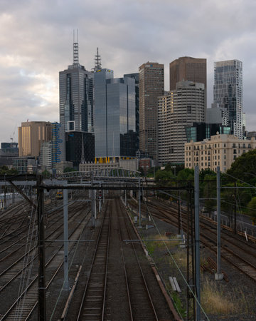 MELBOURNE, AUSTRALIA - 15 November 2019: Train tracks leading towards skyscrapers in Melbourne.