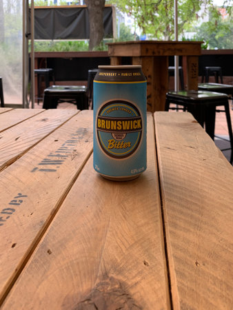 MELBOURNE, AUSTRALIA - 7 February 2020: A can of Brunswick Bitter sitting on a wooden table.のeditorial素材