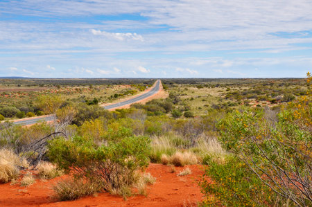 A long straight road disappearing into the distance in the Norther Territory in Australia