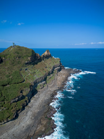 Aerial view of Bitoujiao lighthouse, a famous scenery of Taiwan northeast corner. Birds eye view in Bitoujiao cape, Ruifang district, New Taipei, Taiwan.の写真素材