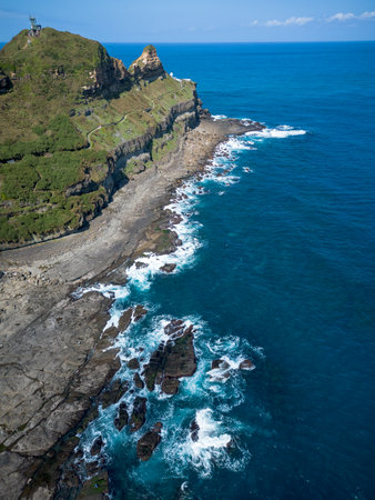 Aerial view of Bitoujiao lighthouse, a famous scenery of Taiwan northeast corner. Birds eye view in Bitoujiao cape, Ruifang district, New Taipei, Taiwan.の写真素材