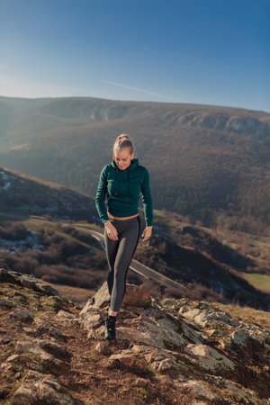 Young fit woman exercising on a mountain topの写真素材