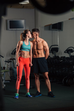 Young fit couple kissing after  a workout togetherの写真素材