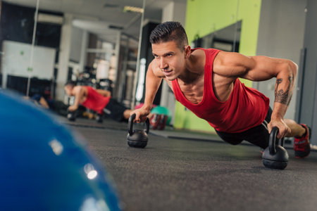 Young muscular man in the gym doing exerciseの写真素材