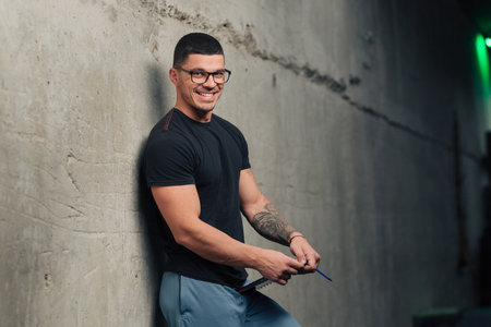 Young fitness trainer in the gym with clipboard smilingの写真素材