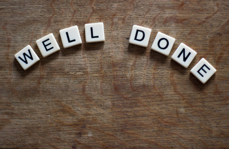 Well Done written in tiles on wooden surfaceの写真素材