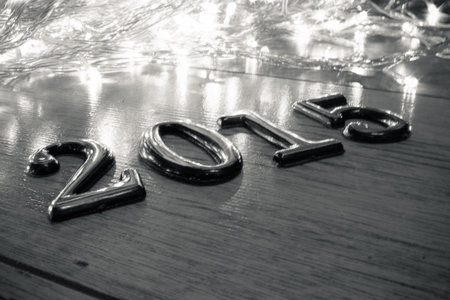 Numbers of 2015 on wooden sirface with defocused LED lights in background