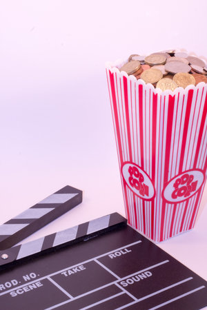 Clapper Board / Film Slate with popcorn container full of coinsの写真素材