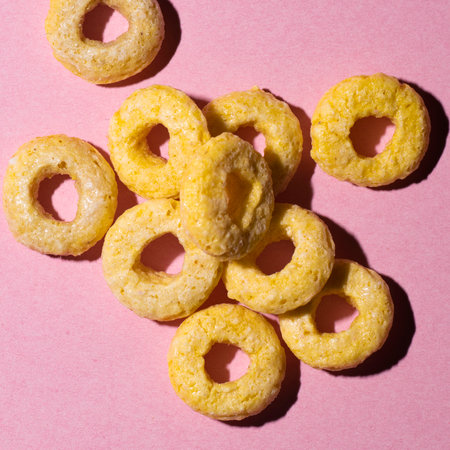 Yellow rings cereals over pink backgroundの写真素材