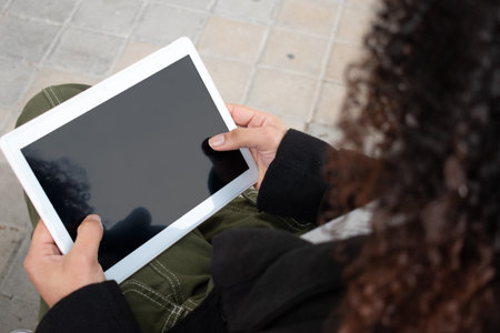 woman without identity holding a tablet