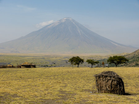 Wooden hut in front of volcano.の写真素材