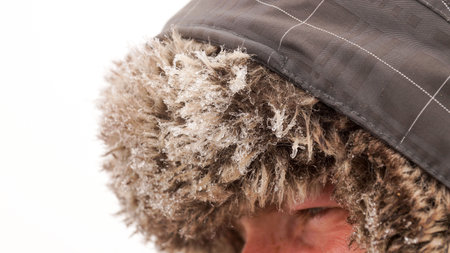 Hiker with ice on his hat.