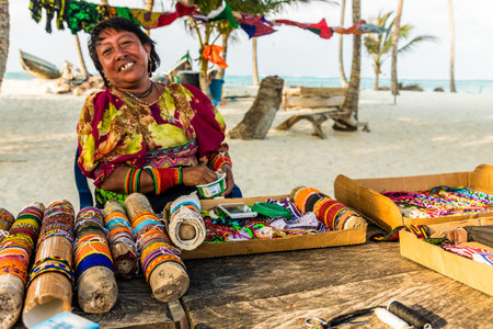 San blas islands, Panama. March 2018. A view of a local Kuna yala lady dressed in traditional clothes and selling her wares in the san Blas Islands, Panama.のeditorial素材