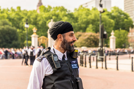 London. June 9 2018. A view of an asian police officer during the Queens birthday celebrations of Trooping the Colourのeditorial素材