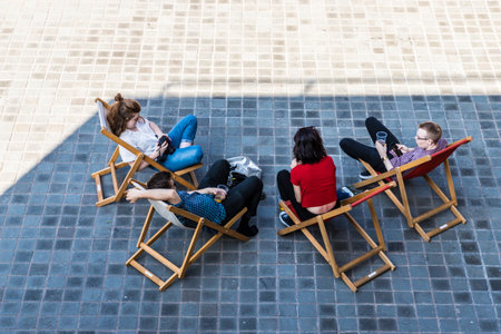 London. June 2018. A view of people relaxing outside the national Theatre along the south bank in Londonのeditorial素材