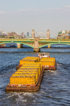 London. June 2018. A view of cargo tugs on the ruiver thames in London.のeditorial素材