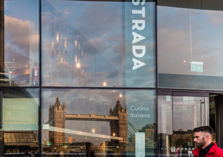 London. June 2018. A view of a reflection of Tower Bridge on the Strada retaurant facade in the city of Londonのeditorial素材