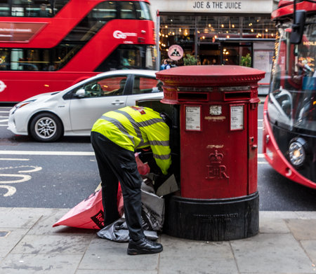 London. June 2018. A view of a postman emptying a post box on regent street in Londonのeditorial素材