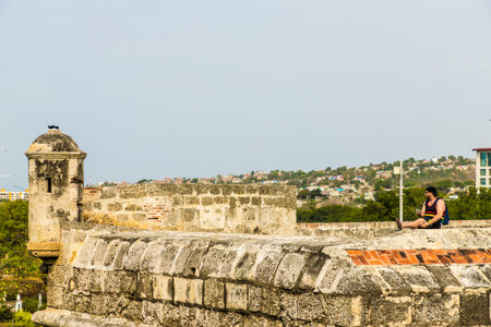 Cartagena, Colombia. March 2018. A view of a tourist relaxing on the fort on the old city walls in Cartagena colombiaのeditorial素材