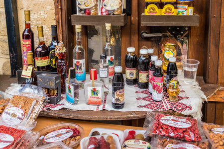 Omodos, Cyprus. May 2018. A typical view of traditional local achoholic drinks for sale in the traditional village Omodos in Cyprus.のeditorial素材