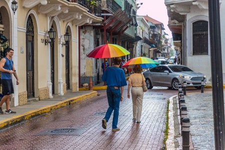 Panama City, Panama. March 2018. A view of tourists walking with a colourful umbrella in Panama City in Panamaのeditorial素材