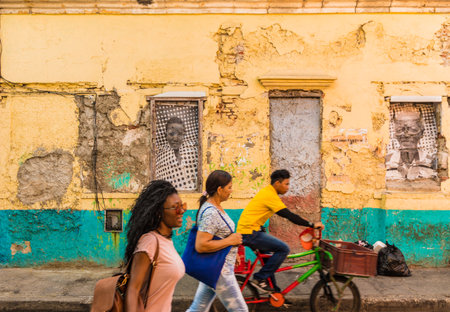 Cartagena, Colombia. March 2018. A view of people walking past a colorful building in Cartagena in Colombiaのeditorial素材