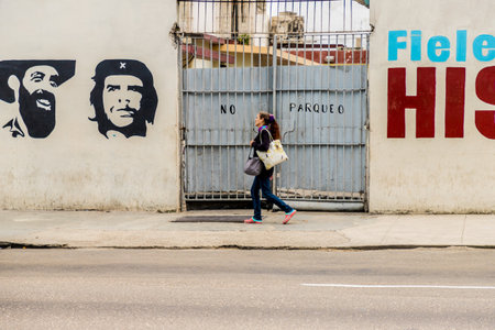 Havana Cuba. january 2018. A typical view of people walking past goverment posters in Havana in Cubaのeditorial素材