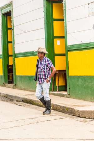 Jardin Colombia. April 2018. A view of a local man walking past colorful colonial architecture in jardin in Colombiaのeditorial素材