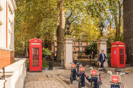 London. November 2018. A view of 2 phone boxes outside the entrance to Mount street Gardens in...