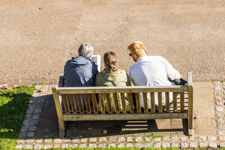 London. November 2018. A view of people sitting on a bench in London