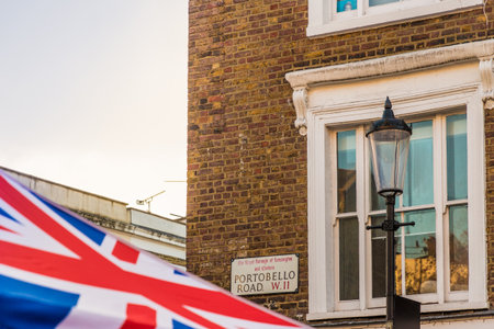 London. November 2018. A view of a portobello road street sign and a union flag at Portobello Road...