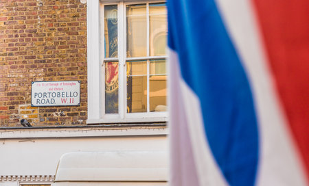 London. November 2018. A view of a portobello road street sign and a union flag at Portobello Road Market in Londonのeditorial素材