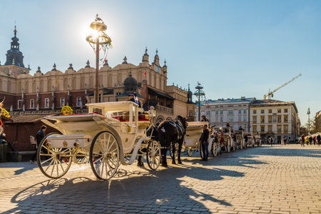 Krakow Poland. April 16 2019. A horse drawn carriage in Krakow medieval Old Town Main Squareのeditorial素材