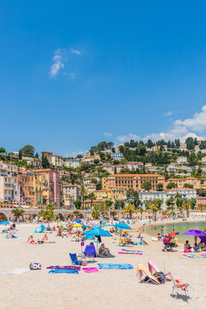 Menton France. 17 June 2019. A view of the beach and colourful buildings in Menton in Franceのeditorial素材