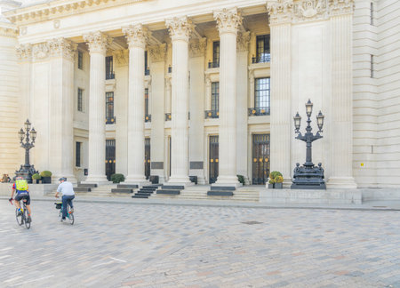 July 2020. London. Cyclists riding past the Four Seasons Hotel in Trinity square, London, England