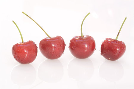 Four cherries in close  up with water dropletsの写真素材