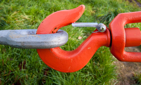 Orange hook and eye under tension being used to reinforce a suspension bridgeの写真素材