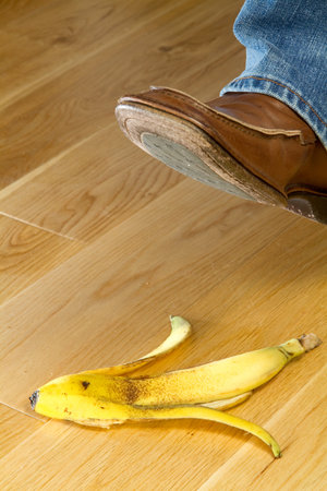 Close up of a foot about to tread on a banana skinの写真素材