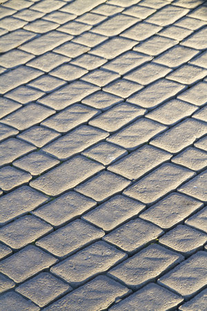 Close up of street cobblestones illuminated by setting sunの写真素材