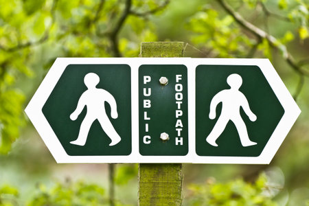 Public footpath sign pointing left and rightの写真素材
