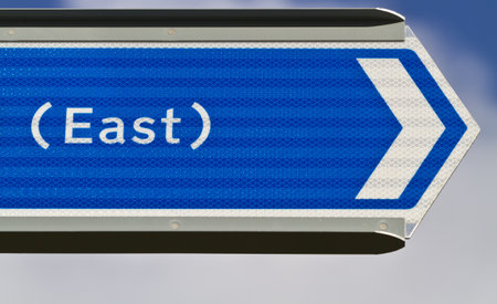 Blue sign pointing eastの写真素材