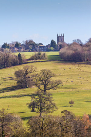 View across fields to Stowe on the Wold, Cotswolds, Gloucestershire, UKの写真素材