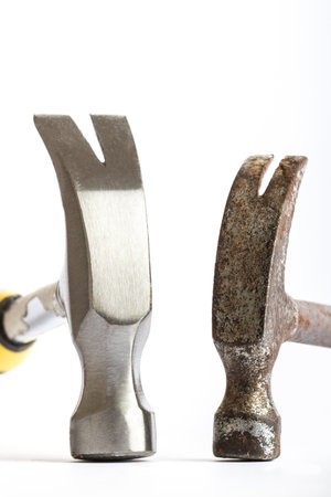 Two hammers, one old one new on a white backgroundの写真素材