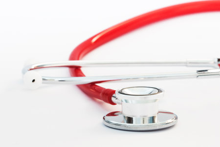 Close up of a red stethoscope and ear pieceの写真素材
