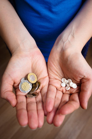 Woman hands with drugs and money, expensive medicineの写真素材