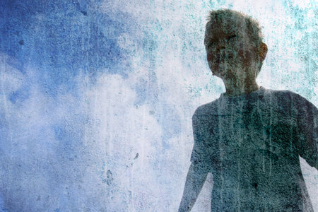 Child under a cloudy skyの写真素材