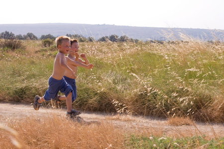 Young children running in the natureの写真素材
