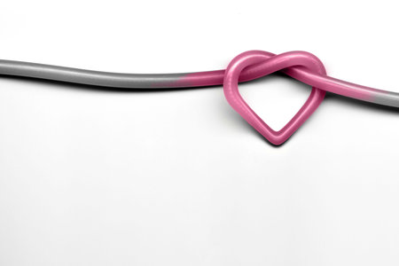 pink heart knot on white backgroundの写真素材