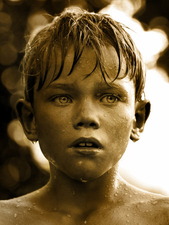 Vintage portrait of a child with water drop on faceの写真素材
